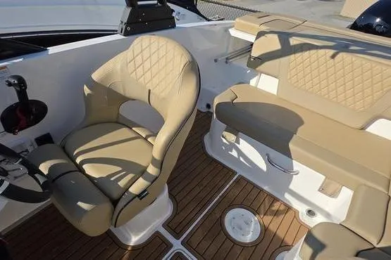 Slide: The Image of 2025 Bayliner VR5 OB boat interior with tan seating and wood-style flooring. - 21
