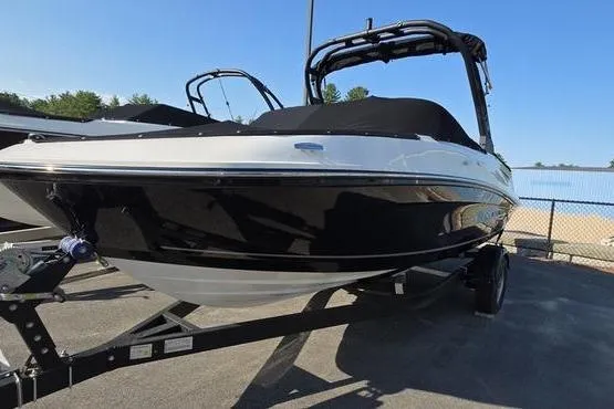 Slide: The Image of 2025 Bayliner VR5 OB boat on trailer, black and white design, parked outdoors. - 4