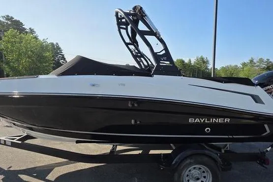 Slide: The Image of 2025 Bayliner VR5 OB boat on trailer, black and white design, parked outdoors. - 5