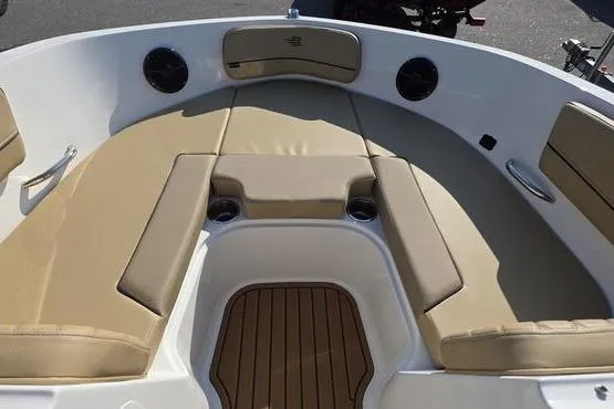 Slide: The Image of 2025 Bayliner VR5 OB boat interior with tan seating and wood-style flooring. - 7