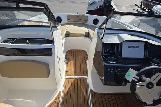 Slide: The Image of 2025 Bayliner VR5 OB boat interior with wood flooring and modern dashboard. - 8