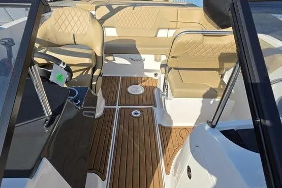 Slide: The Image of 2025 Bayliner VR5 OB boat interior with tan seating and wood-style flooring. - 9