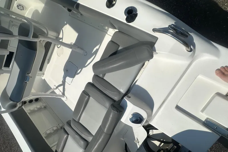 Slide: The Image of 2023 NauticStar 2102 Legacy boat interior with gray seating and white deck. - 10