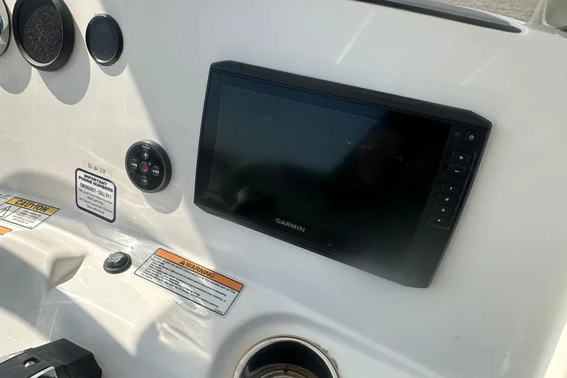 Slide: The Image of 2023 NauticStar 2102 Legacy boat dashboard with Garmin display and control panel. - 12
