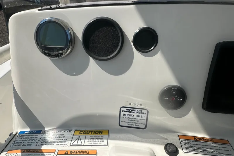 Slide: The Image of Control panel of 2023 NauticStar 2102 Legacy boat with gauges and warning labels. - 13