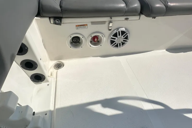 Slide: The Image of 2023 NauticStar 2102 Legacy boat interior with speaker and seating detail. - 17