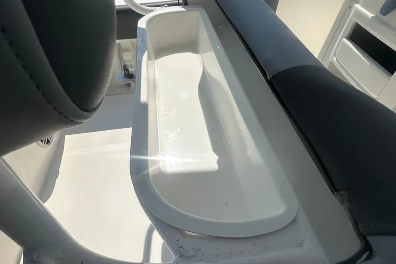 Slide: The Image of 2023 NauticStar 2102 Legacy boat interior detail with seating and storage compartment. - 19