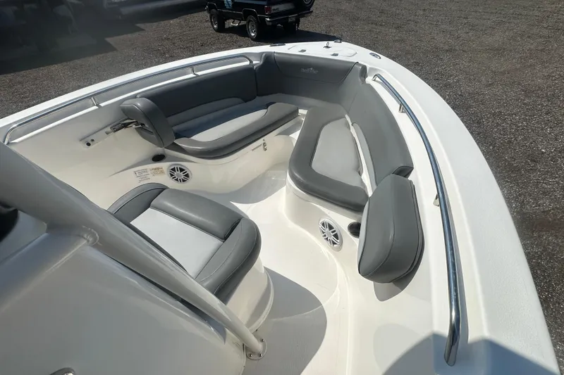 Slide: The Image of 2023 NauticStar 2102 Legacy boat interior with gray seating and speakers. - 25