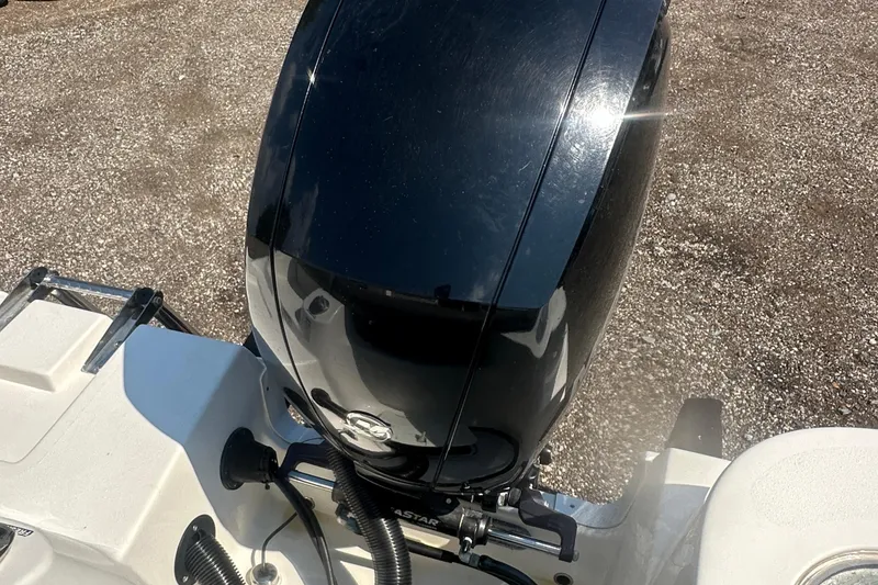 Slide: The Image of 2023 NauticStar 2102 Legacy boat engine, shiny black finish, outdoor setting. - 28