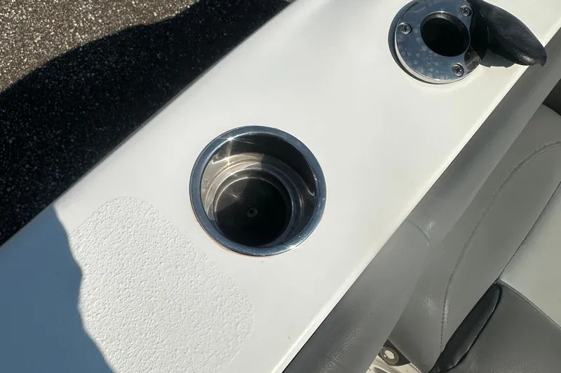 Slide: The Image of 2023 NauticStar 2102 Legacy boat cup holder and rod holder detail. - 29