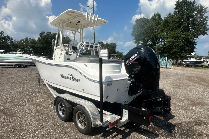 Slide: The Image of 2023 NauticStar 2102 Legacy boat on trailer with Mercury outboard motor. - 3