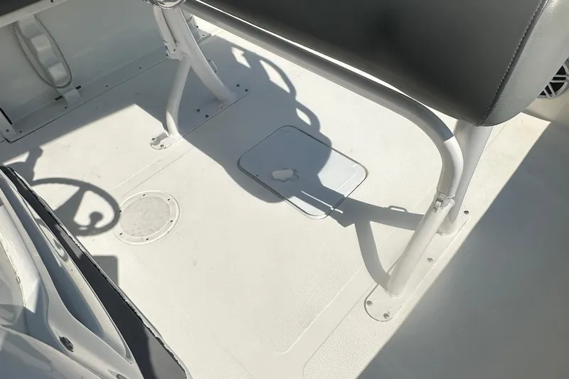 Slide: The Image of 2023 NauticStar 2102 Legacy boat interior with seating and steering wheel. - 32