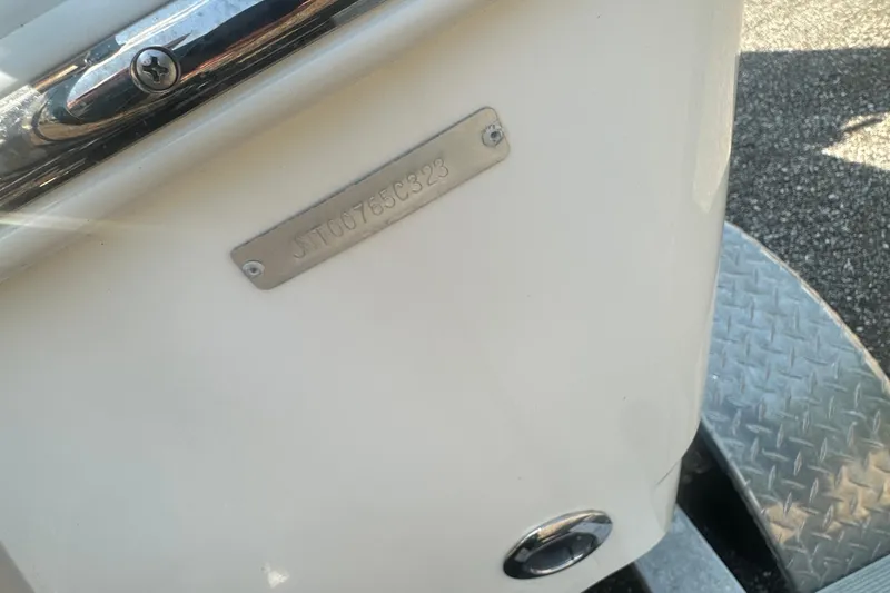 Slide: The Image of 2023 NauticStar 2102 Legacy boat with visible identification plate and metal detailing. - 8