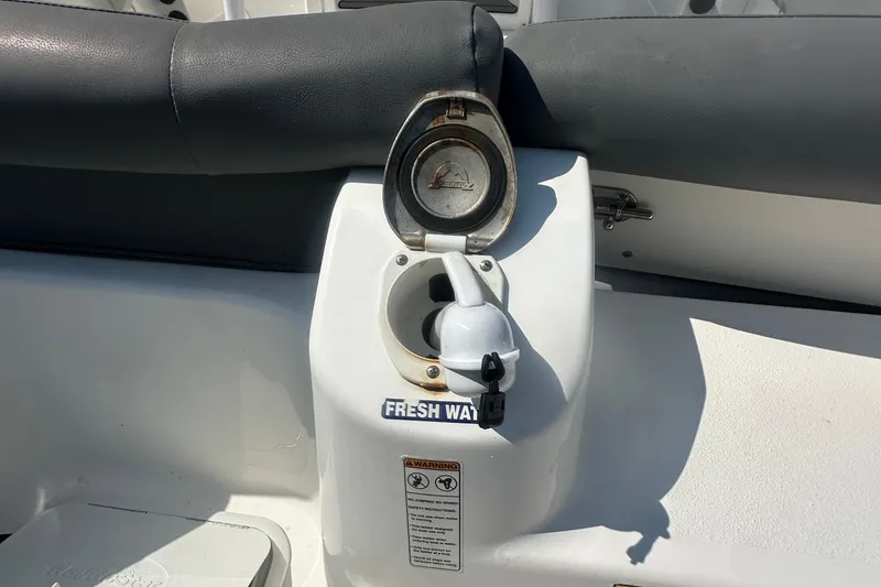 Slide: The Image of 2023 NauticStar 2102 Legacy boat's fresh water fill port with cover open. - 9