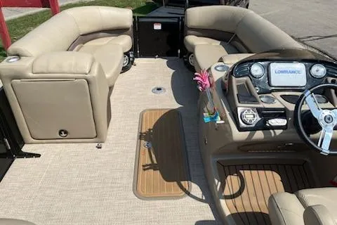 Slide: The Image of 2018 Sun Tracker Regency 220SL boat interior with beige seating and modern dashboard. - 3