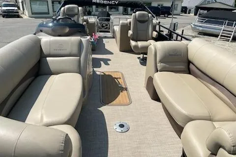 Slide: The Image of 2018 Sun Tracker Regency 220SL pontoon boat with beige seating and spacious deck layout. - 6