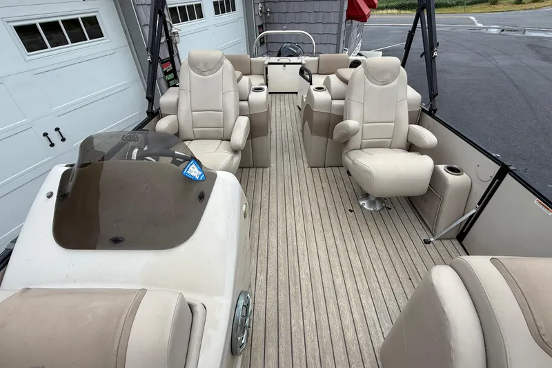 Slide: The Image of 2018 Avalon 2385 Catalina Rear Lounger Tri-Toon boat interior with beige seating. - 19