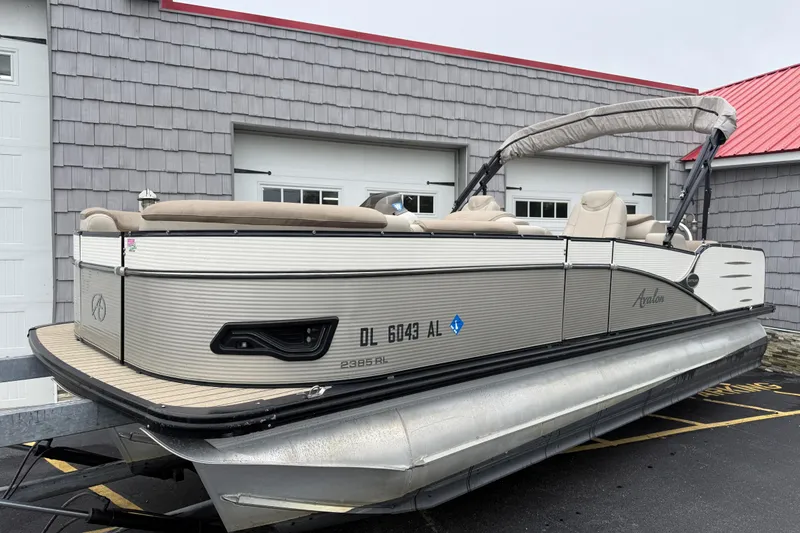 Slide: The Image of 2018 Avalon 2385 Catalina Rear Lounger Tri Toon boat, high performance, parked outside a building. - 21