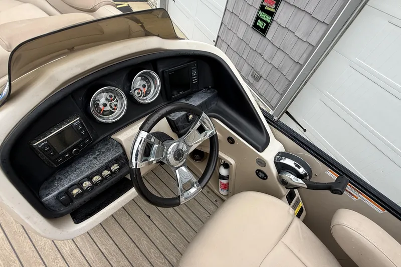 Slide: The Image of 2018 Avalon 2385 Catalina boat dashboard with steering wheel and control panel. - 24