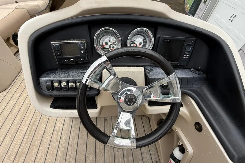 Slide: The Image of Steering console of 2018 Avalon 2385 Catalina Rear Lounger, featuring gauges and controls. - 25