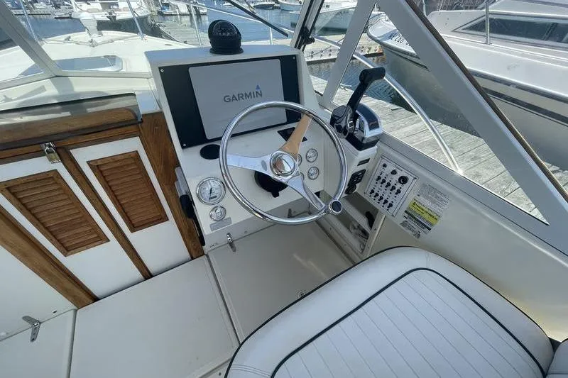 Slide: The Image of Cockpit of 2004 Limestone 24 boat with Garmin navigation system and steering wheel. - 10