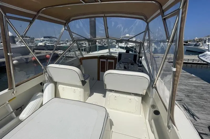 Slide: The Image of 2004 Limestone 24 boat interior with canopy, docked at marina. - 11