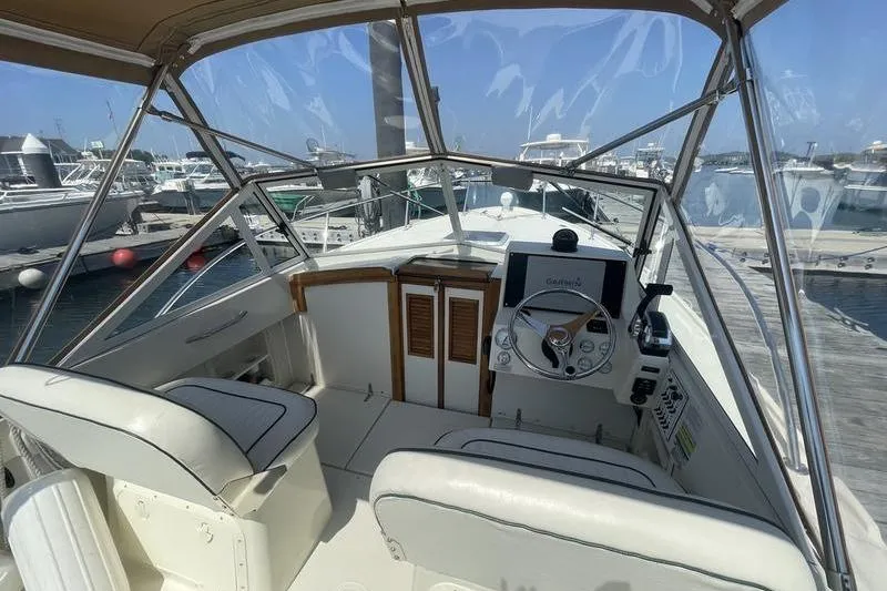 Slide: The Image of 2004 Limestone 24 boat interior with helm, steering wheel, and navigation equipment at marina. - 9
