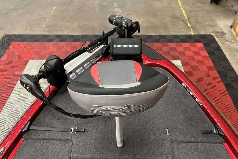 Slide: The Image of 2014 Skeeter ZX 190 boat with Humminbird electronics and cushioned seat on red and black flooring. - 4