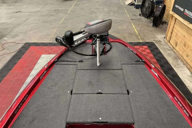 Slide: The Image of 2014 Skeeter ZX 190 boat interior with trolling motor and carpeted deck. - 6
