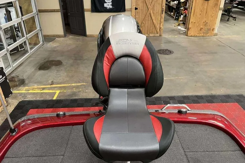 Slide: The Image of 2014 Skeeter ZX 190 boat seat with red and gray upholstery in a showroom. - 7