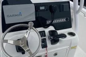 Slide: The Image of 2020 Tidewater 220 CC boat console with Garmin navigation and steering wheel. - 10