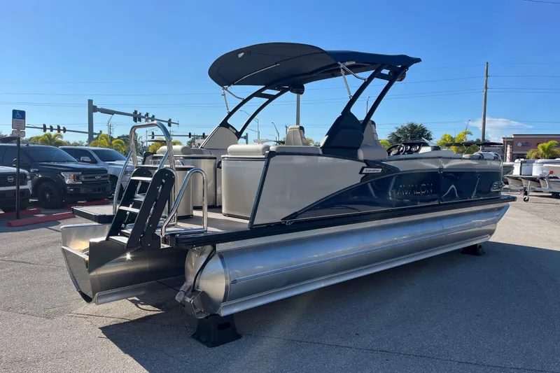 Slide: The Image of 2026 Avalon 2385 Catalina Quad Lounger Tri Toon boat displayed outdoors. - 5