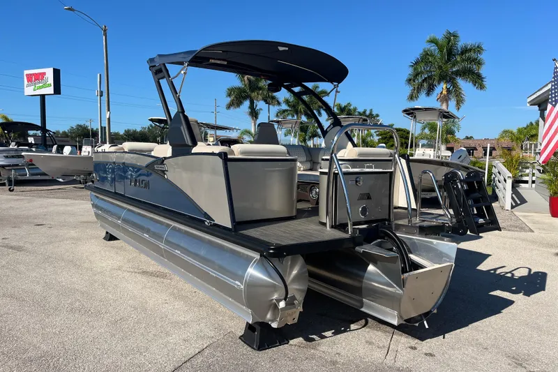 Slide: The Image of 2026 Avalon 2385 Catalina Quad Lounger Tri Toon boat displayed outdoors on a sunny day. - 7