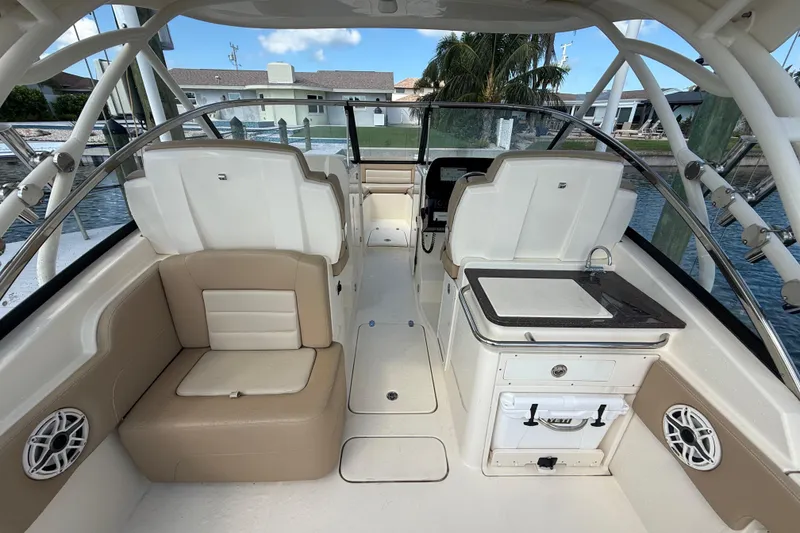 Slide: The Image of 2023 Scout 255 Dorado boat interior with seating, sink, and storage. - 14
