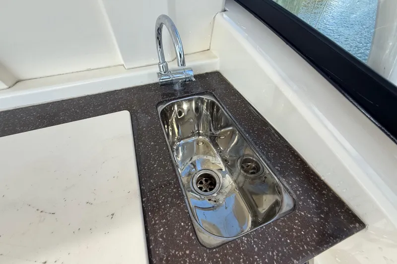 Slide: The Image of Stainless steel sink on 2023 Scout 255 Dorado boat with sleek countertop design. - 17
