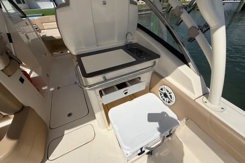 Slide: The Image of 2023 Scout 255 Dorado boat interior with sink, storage, and seating. - 20