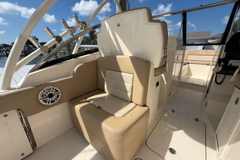 Slide: The Image of 2023 Scout 255 Dorado boat interior with beige seating and rod holders. - 21