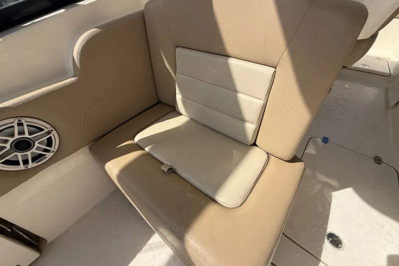 Slide: The Image of 2023 Scout 255 Dorado boat seat with beige upholstery and speaker detail. - 22