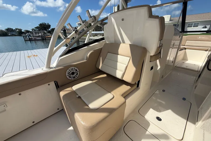 Slide: The Image of 2023 Scout 255 Dorado boat interior with beige seating and rod holders. - 24