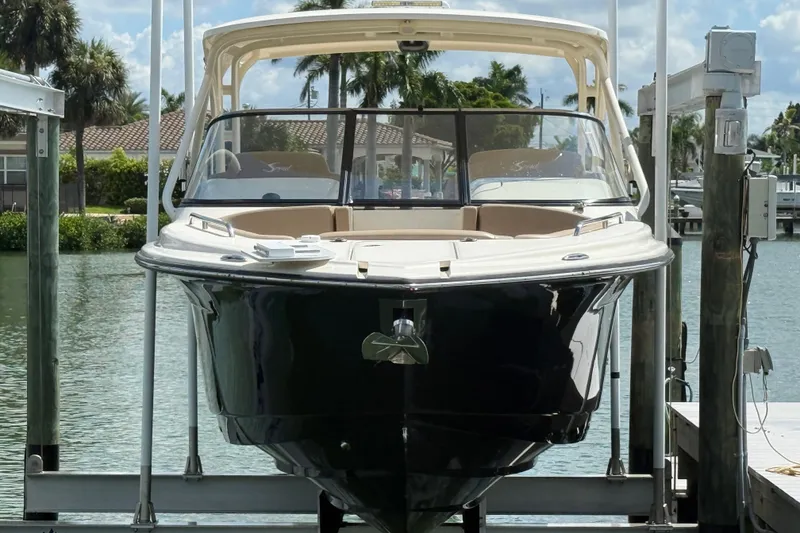 Slide: The Image of 2023 Scout 255 Dorado boat docked on a sunny waterfront. - 3