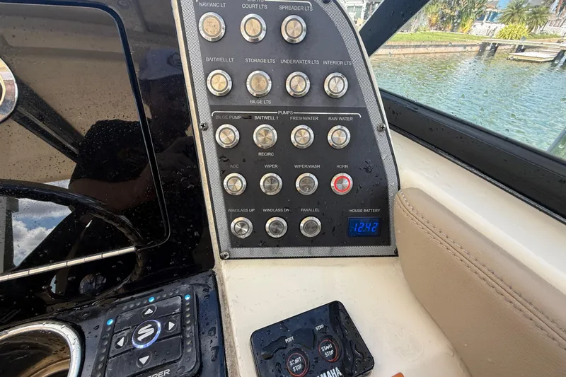 Slide: The Image of Control panel of 2023 Scout 255 Dorado boat with various switches and digital display. - 30