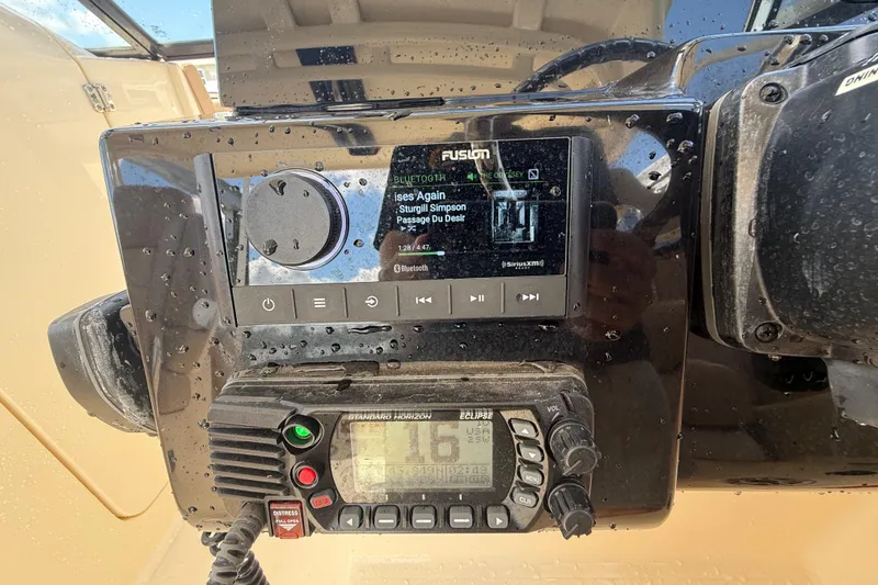 Slide: The Image of 2023 Scout 255 Dorado dashboard with Fusion stereo and Standard Horizon radio. - 33