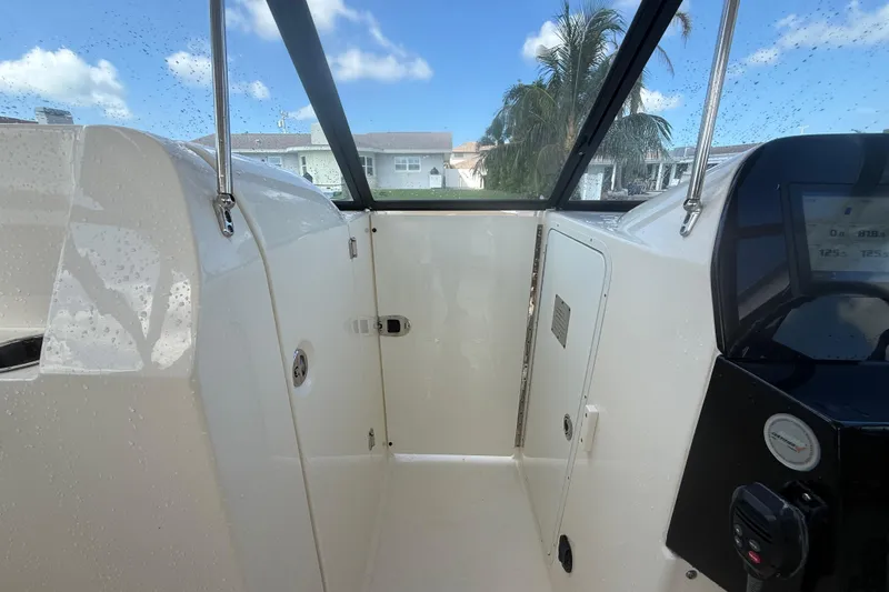 Slide: The Image of 2023 Scout 255 Dorado boat interior with dashboard and wet surfaces. - 36
