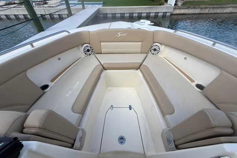 Slide: The Image of 2023 Scout 255 Dorado boat interior with beige seating and speakers. - 44