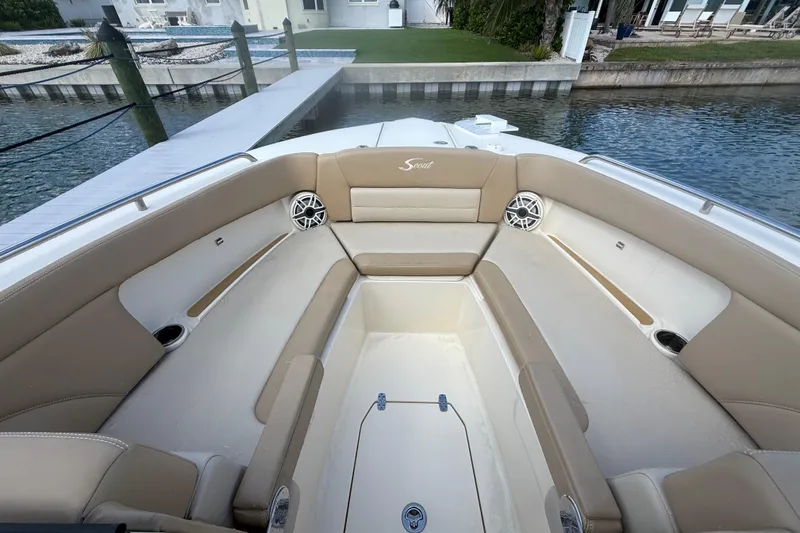 Slide: The Image of 2023 Scout 255 Dorado boat interior with beige seating and waterfront view. - 45