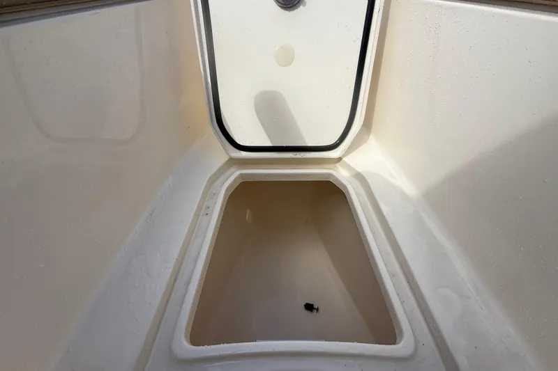 Slide: The Image of 2023 Scout 255 Dorado storage compartment, open and empty, showcasing interior space. - 47
