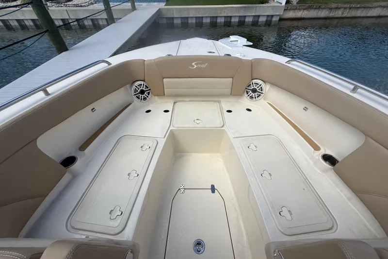 Slide: The Image of 2023 Scout 255 Dorado boat interior with beige seating and storage compartments. - 50