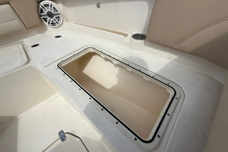 Slide: The Image of 2023 Scout 255 Dorado boat interior with storage compartment and speaker. - 54
