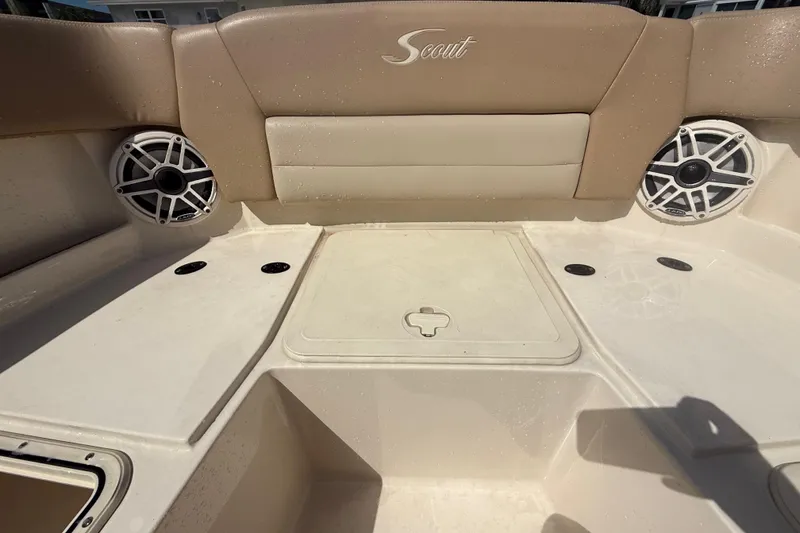 Slide: The Image of 2023 Scout 255 Dorado boat interior with speakers and seating area. - 55
