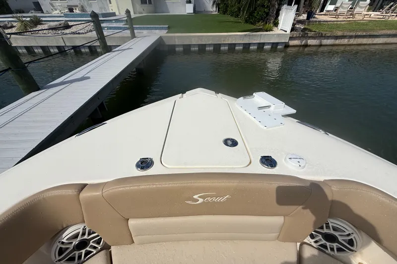 Slide: The Image of 2023 Scout 255 Dorado boat docked, featuring tan seating and sleek design. - 57